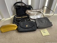 Photo showing six assorted purses of different sizes, colors, and styles on a light surface.