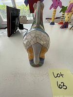 Bottom view of ceramic donkey figurine showing flat base and glaze finish