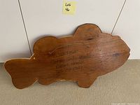 Back of wood wall art showing artist signature and details.