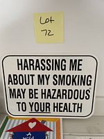 Close-up of rectangular metal sign stating 'Harassing me about my smoking may be hazardous to your health'