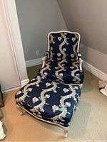 Armchair and footstool together showing overall style and matching upholstery