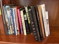 Bookshelf displaying 9 hardcover non-fiction books with various titles related to history, art, culture, and geography.