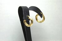 Front angled view of both 14K gold hoop earrings mounted on black earring stand.