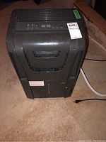Front view of Danby Premiere dehumidifier showing front grille and control panel.
