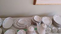 Overview photo showing plates of various sizes and serving dishes arranged on a table