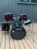Front view of full drum kit showing bass drum, mounted toms, floor tom, snare, pedal and stands