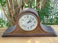 Front view of the 1930s wooden mantel clock with admiral hat style case and Plymouth branded dial.