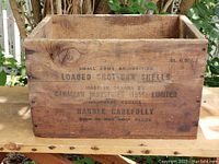 Front view of the wooden box showing all stamped text about small arms ammunition and manufacturing details.