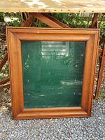 Front view of the pine hanging shadow box, showing the wooden frame and glass front with green felt background.