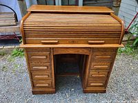 Front view of full desk showing roll-top closed and drawer banks