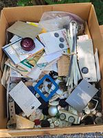 Overview of entire box containing assorted old buttons and sewing items