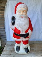 Full front view of the vintage 1950s plastic blow mold Santa Claus figure showing the detailed facial features, red suit, and black boots.