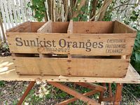 Front view showing Sunkist Oranges stamping and three compartments