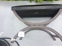 Lower view showing curved metal legs with X-frame configuration