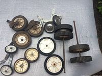 All wheels laid out on a fabric background, showing variety of sizes and types.