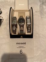Three ladies watches displayed in a black and white Movado watch box, showing the front of all watches.