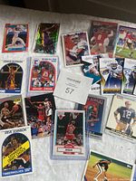 Photo showing a spread of basketball, football, and baseball cards including Michael Jordan, Dennis Rodman, Charles Barkley, Steve Johnson, Kobe Bryant, Rip Roberts, Joe Montana, and Blake Bortles.