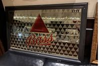 Photo of large Bass English Pale Ale pub bar mirror with branded logo and geometric pattern.