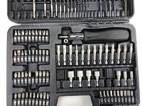 Top down view of the inner case packed with various screwdriver bits, socket bits, drill bits, ratcheting handle, and bit holder/extension arranged in molded slots.