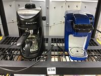 Photo showing both machines side by side on black shelving: Capresso espresso machine on left, blue single brew coffee maker on right.
