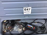 Dremel rotary tool with power cord and various accessory attachments in plastic case