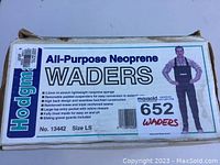 Photo of inner box label describing Hodgman All-Purpose Neoprene Waders, size LS with detailed features.