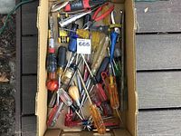 Box of mixed screwdrivers, many with plastic and wooden handles, assorted sizes and types.
