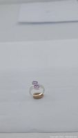 Full view of natural purple amethyst ring showing amethyst stones and silver band.