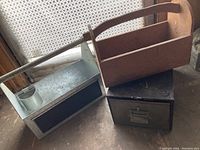 Photo showing the metal drawer unit alongside the two wooden tool totes with one showing the drilled holes compartment