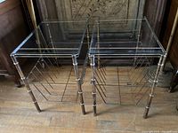 Pair of vintage brass finish faux bamboo metal side tables with glass tops and wire racks underneath