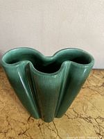Top angled view showing the scalloped rim and ombre green glaze.
