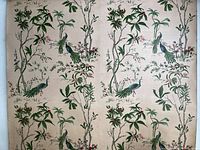 Full view of the wallpapered vinyl roller showing repeating bird and floral pattern on beige background.