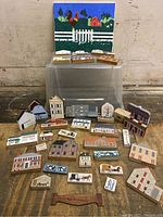 Full lot arranged on floor showing numerous Cat's Meow wooden landmark blocks and farm painting propped up in background