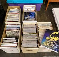 Five large cardboard boxes filled with stacks of magazines and comic books, diverse titles visible
