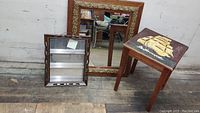 Lot showing all three items: large wood framed mirror, small wood 3-tier mirrored curio shelf, small nautical painted side table