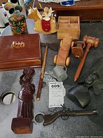 Overview of lot items showing wooden figurines, boxes, toys, figurines, gavel, and carved birds