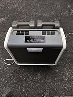 Front and top view of the Sunbeam dehumidifier with control panel visible and two water tanks on the back.