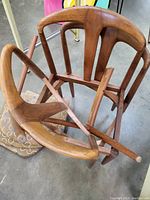 Pile of disassembled solid teak chair frames stacked