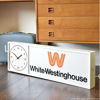 Full front view of illuminated sign with integrated clock