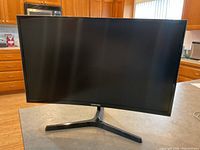 Front view of the Samsung curved computer monitor showing the full screen and stand