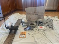 Vintage Rival Electric Food Slicer model 1030V with chrome body, various blades and attachments, original box and instruction manual, and electric cord visible.