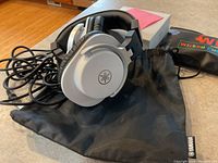 Yamaha HPH-MT5 silver and black professional monitor headphones with cable and carrying pouch shown on flat surface