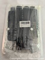 Five sealed packages each containing 10 black hair combs of varied designs, showing overall packaging and comb details.