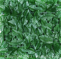 Close-up photo showing dense, artificial green ivy leaves on lattice backing to simulate real ivy for garden privacy screen panels.
