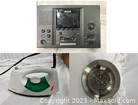 Top view of all three items: RCA alarm clock radio, Black+Decker iron, and metal shower head.
