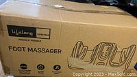 Closed cardboard box labeled "Lifelong Lifestyle Foot Massager" with illustrated product outline