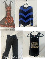 Sleeveless v-neck floral dress, blue and black striped sweater, black tank top with gold lettering, and black and white striped pants