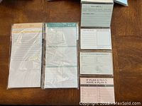 Two different magnetic memo pads with printed headings and lined sheet designs in plastic packaging on wood surface.
