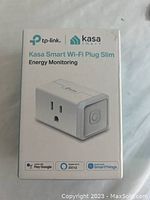 Front view of TP-Link Kasa Smart Wi-Fi Plug Slim box showing product image and features like energy monitoring, Alexa, Google Assistant, and SmartThings compatibility.