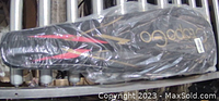 Two sets of carbon fiber badminton rackets and carrying bag in packaging.